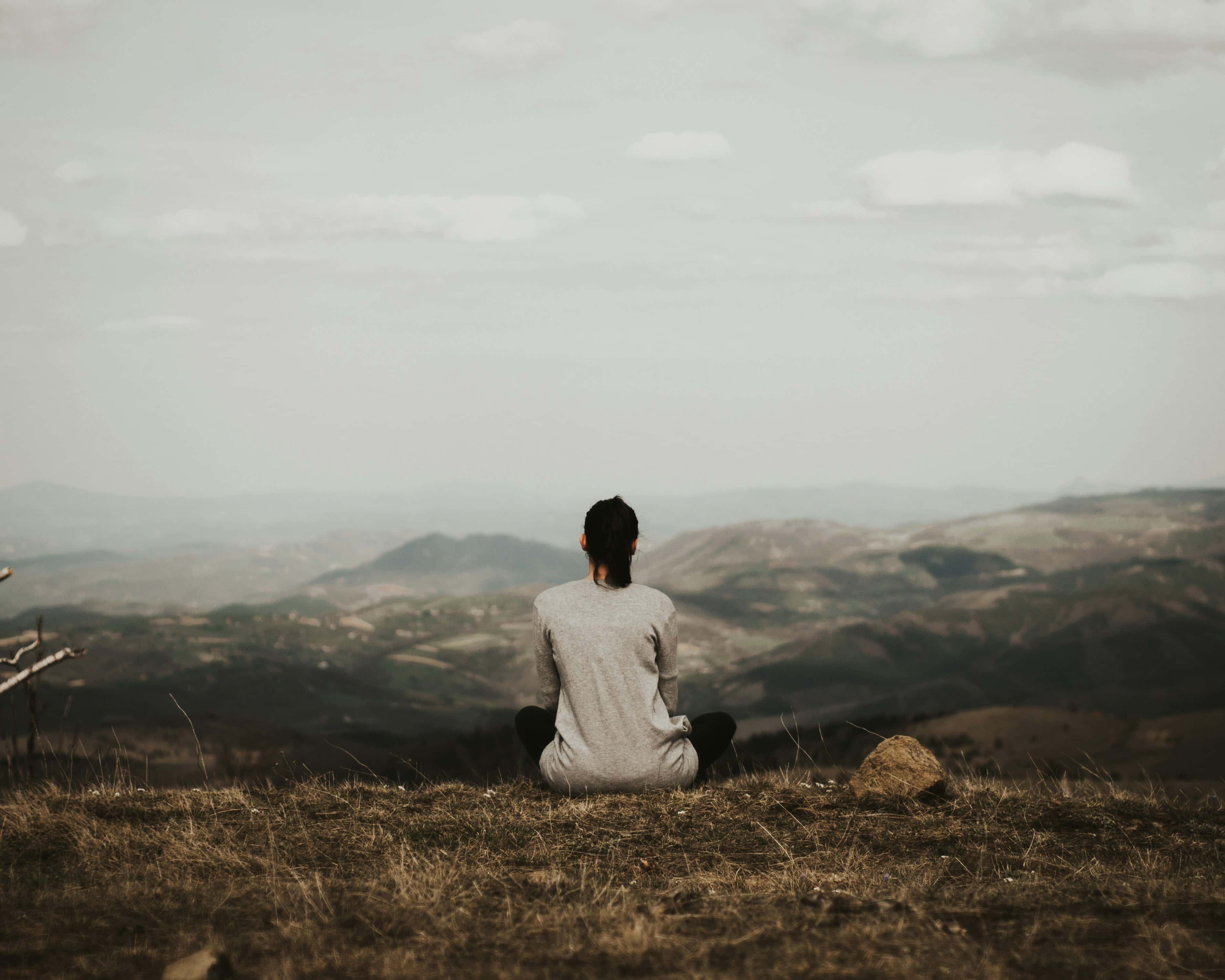 Sitting in stillness above a misty valley