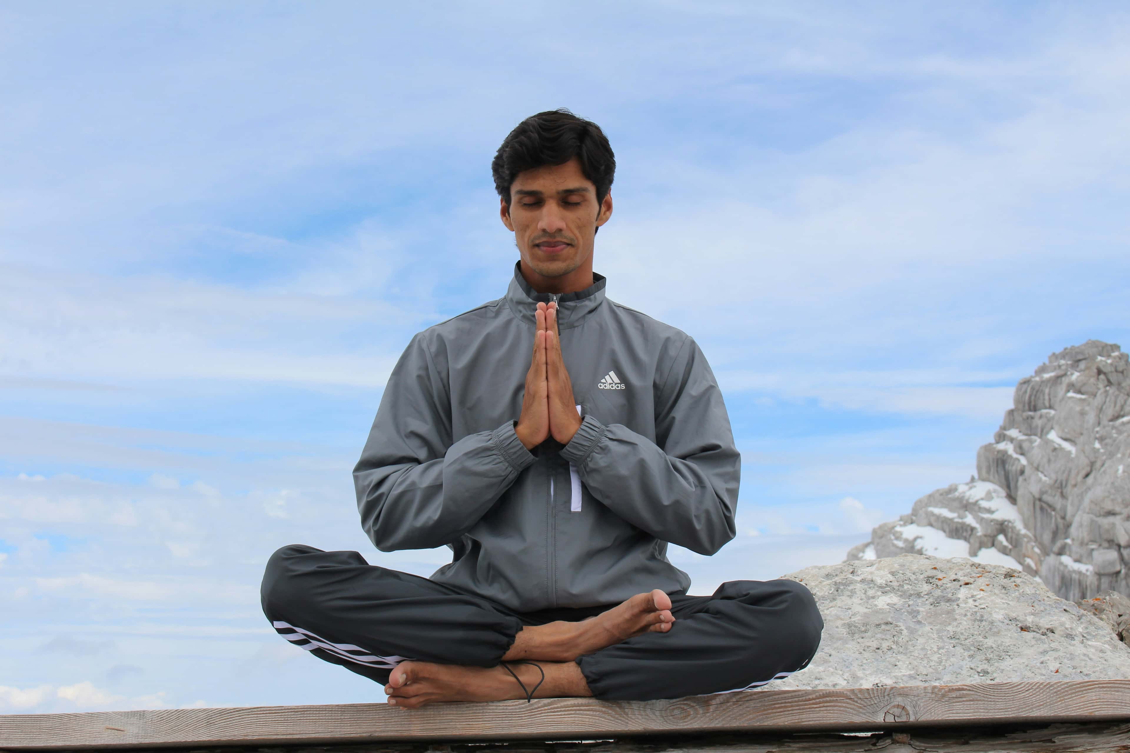 Yogi meditating with hands in prayer