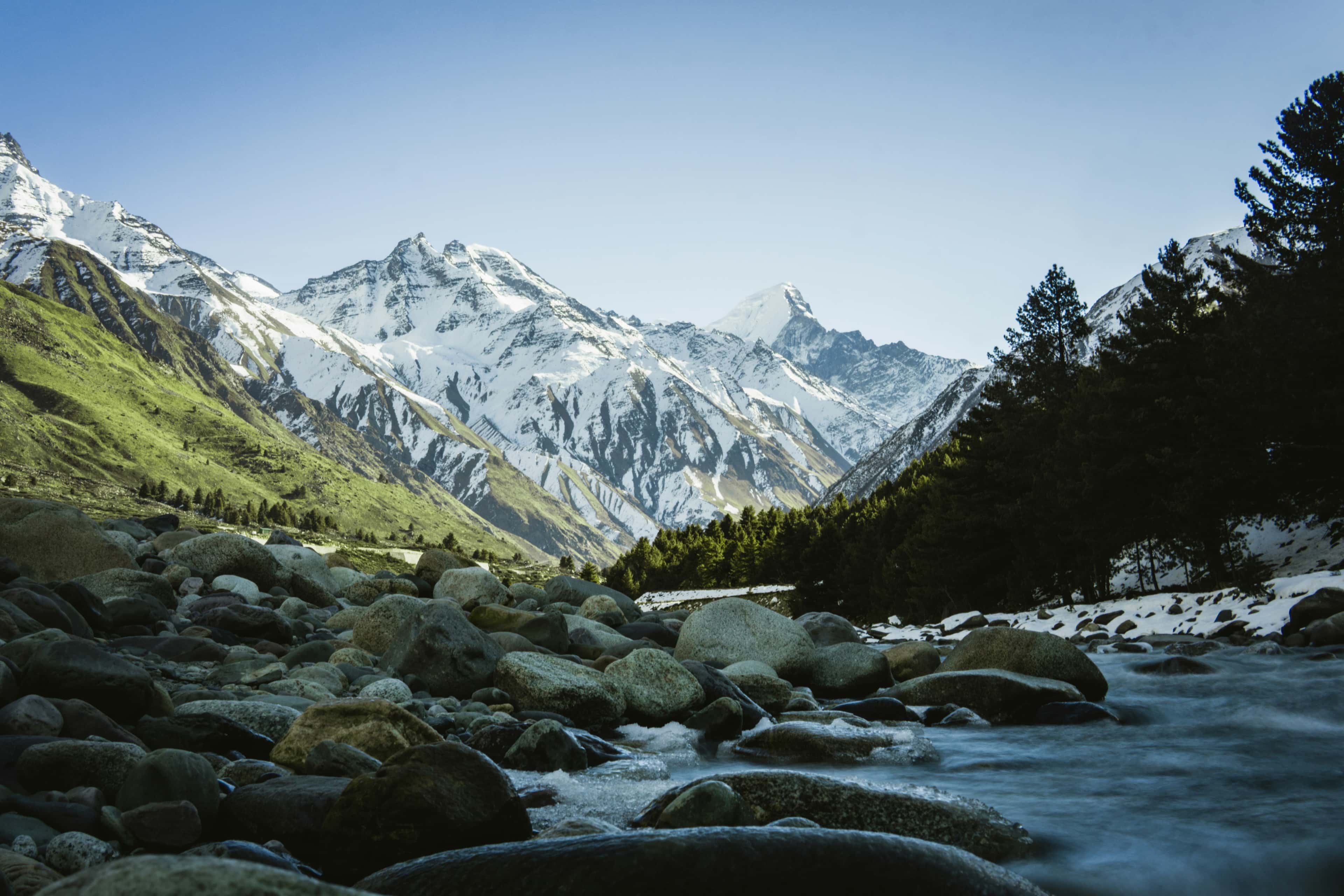 Rocky mountain river with snow peaks in the distance