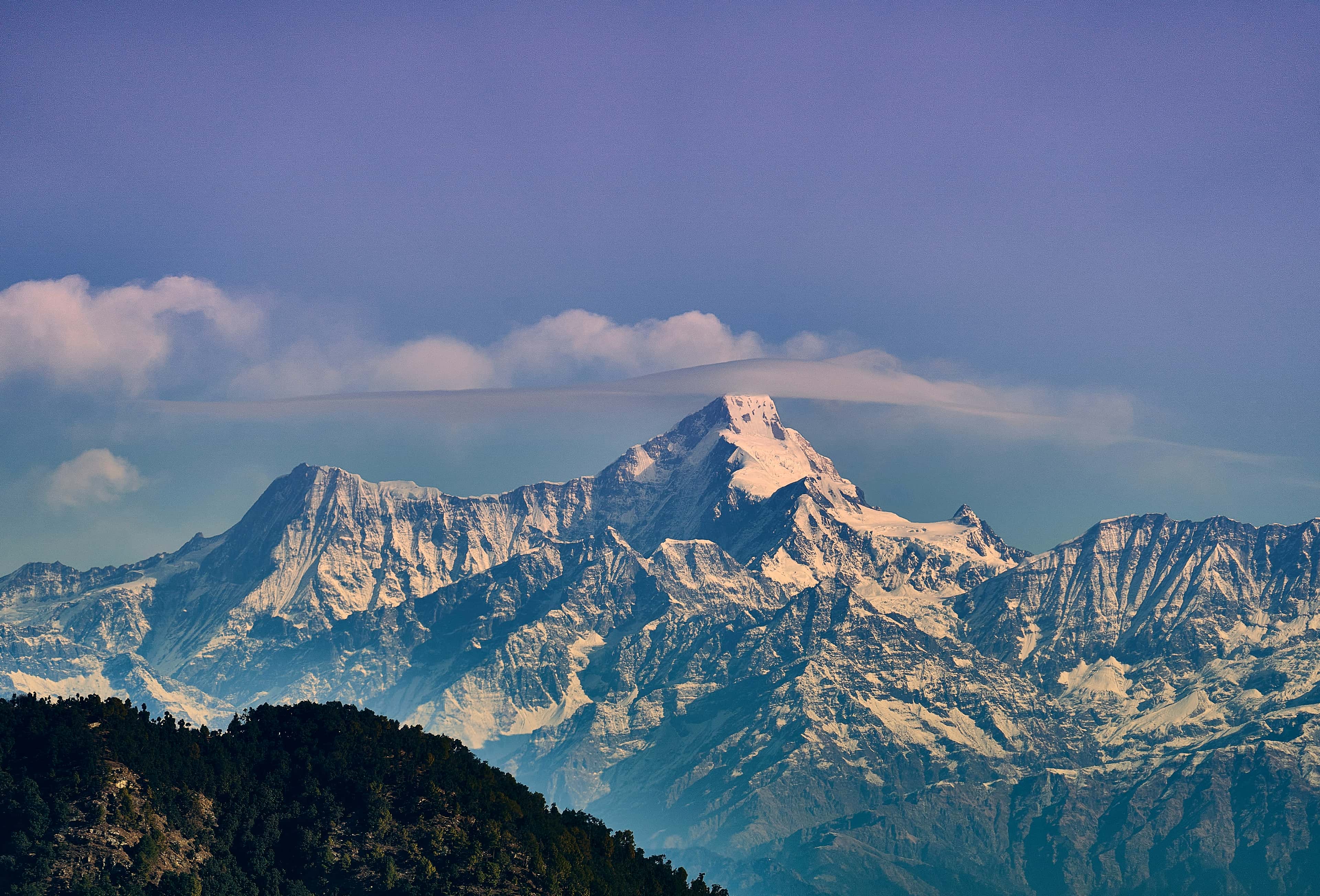 Snow-covered Himalayan range under a soft sky