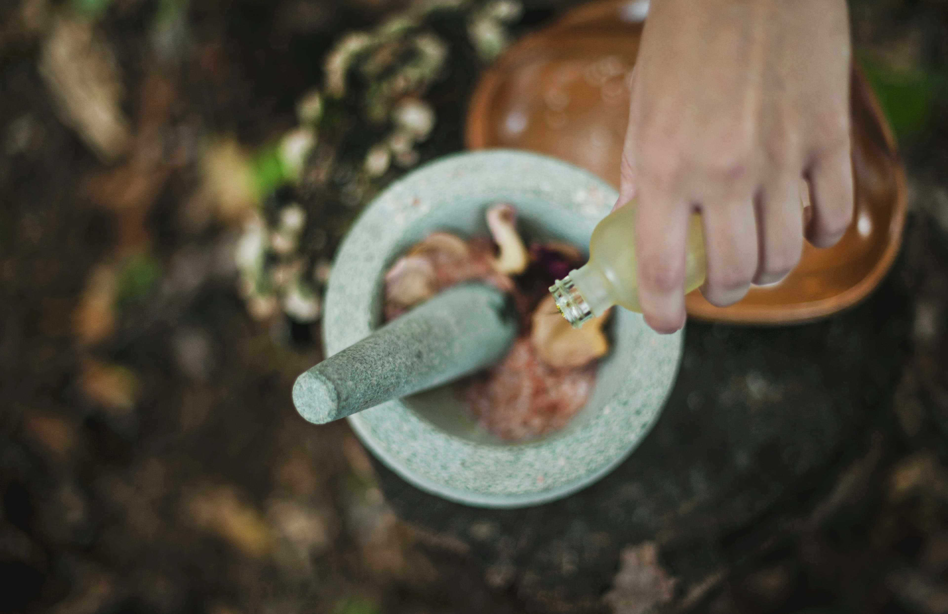 Herbal oil poured into a stone mortar