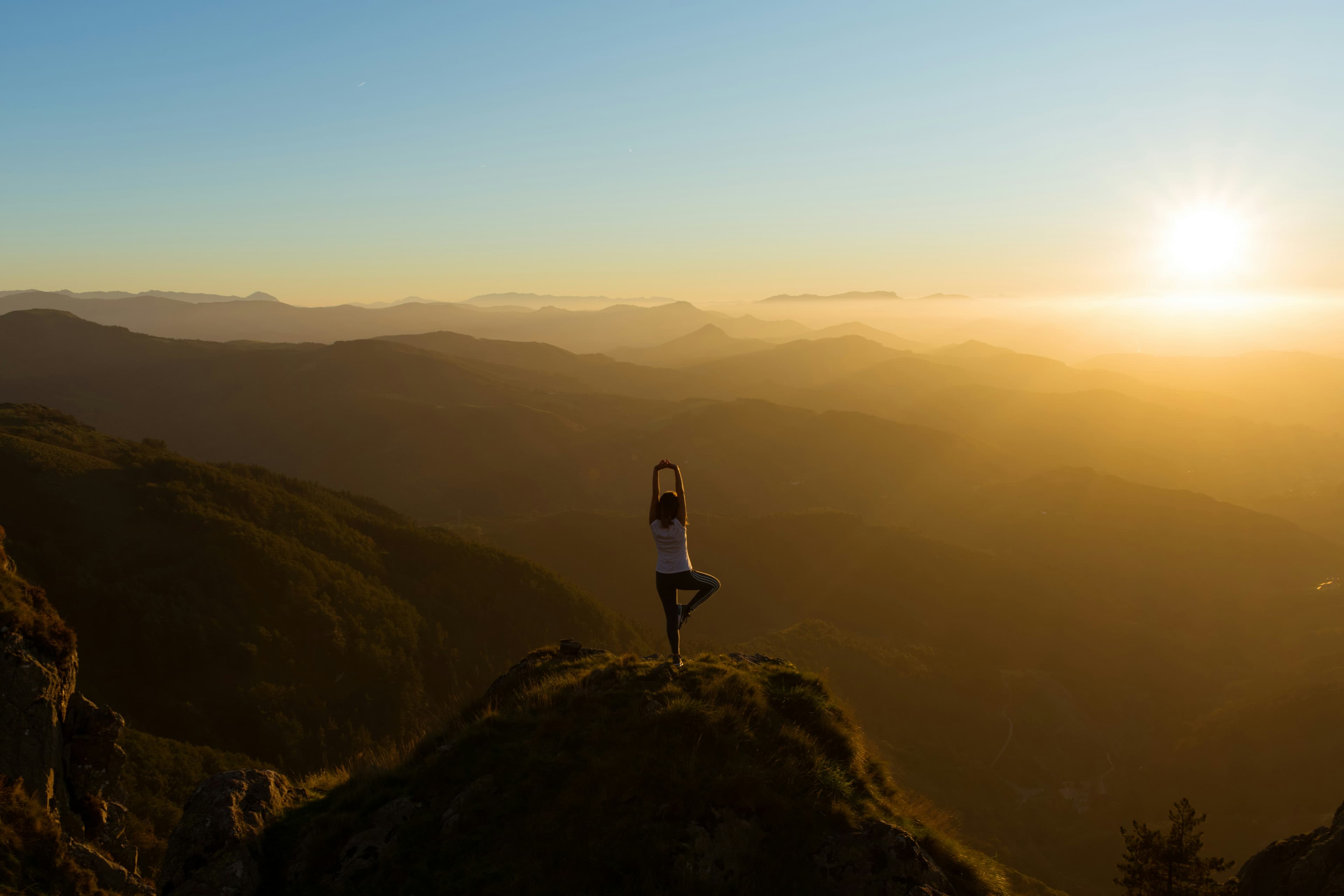 Stretching on a mountain top at sunrise