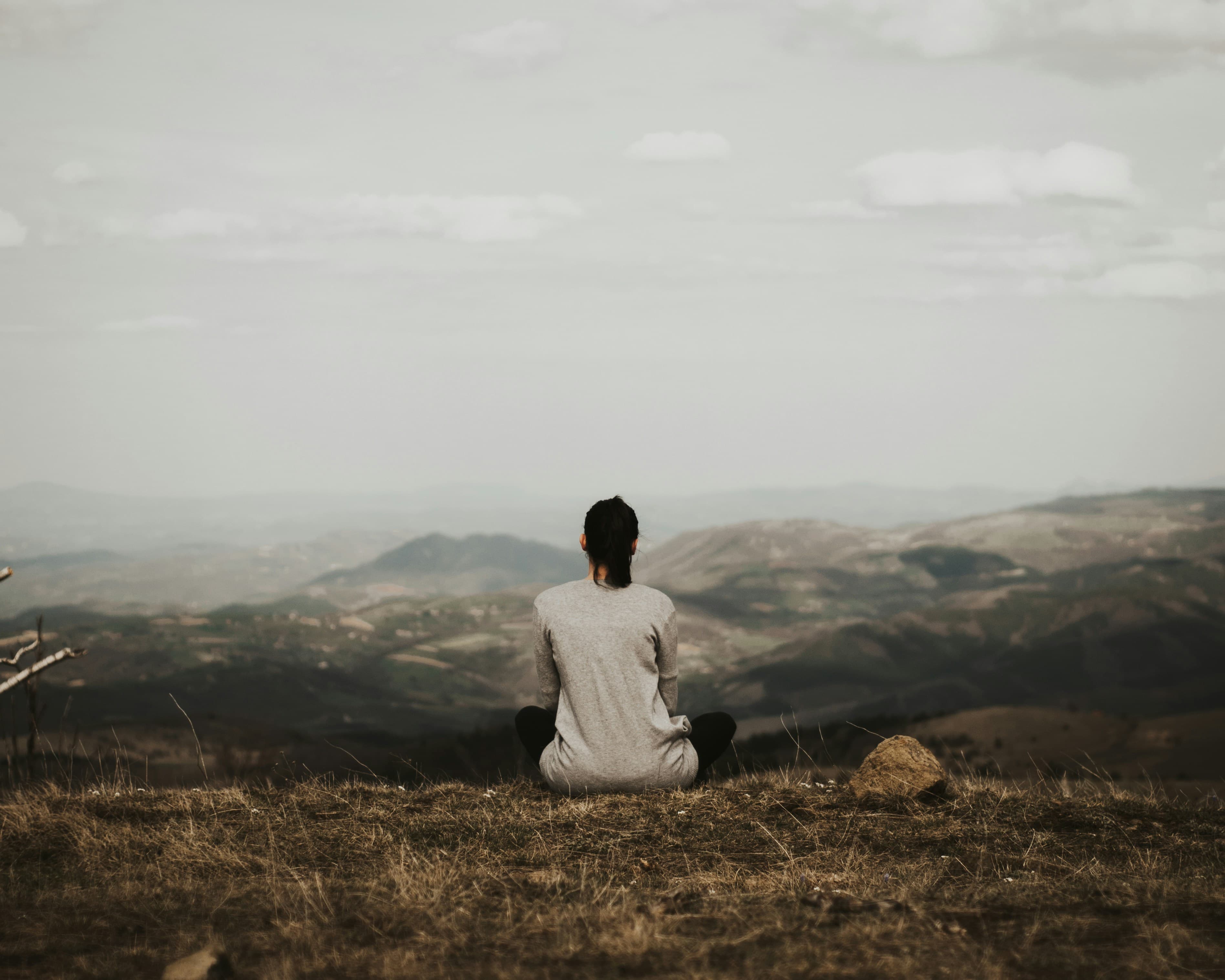 Sitting in stillness above a misty valley