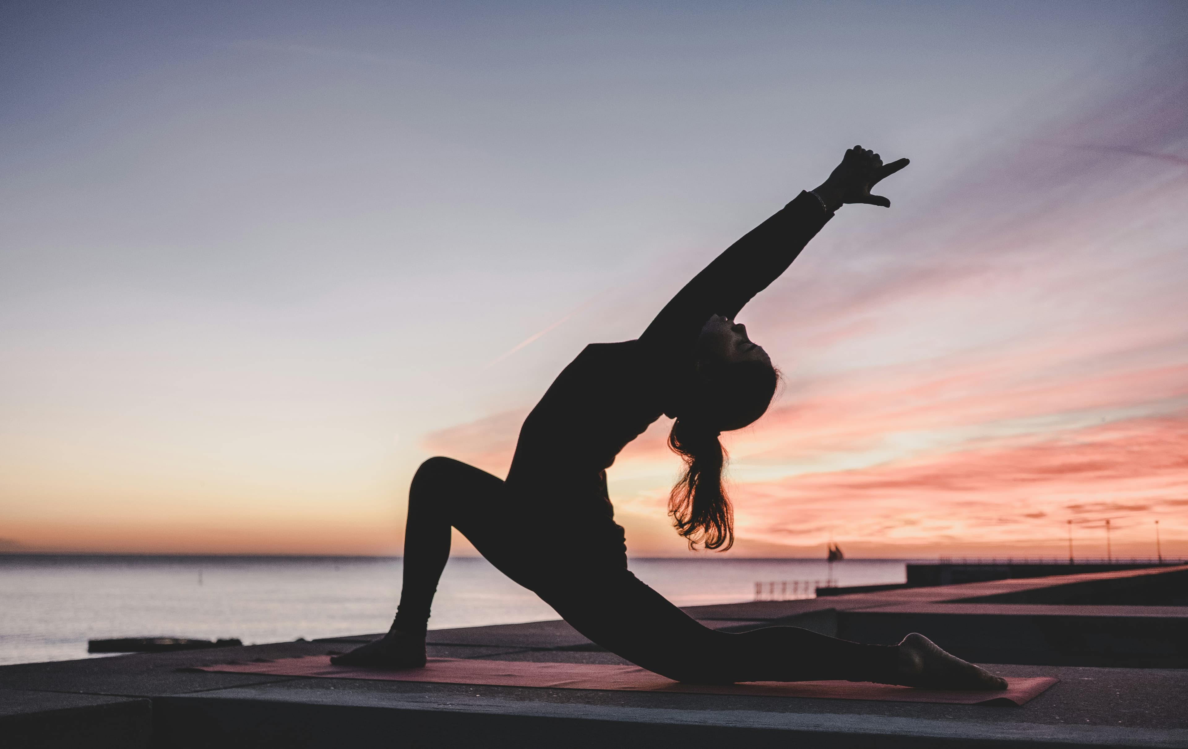 Yoga silhouette against the evening sky