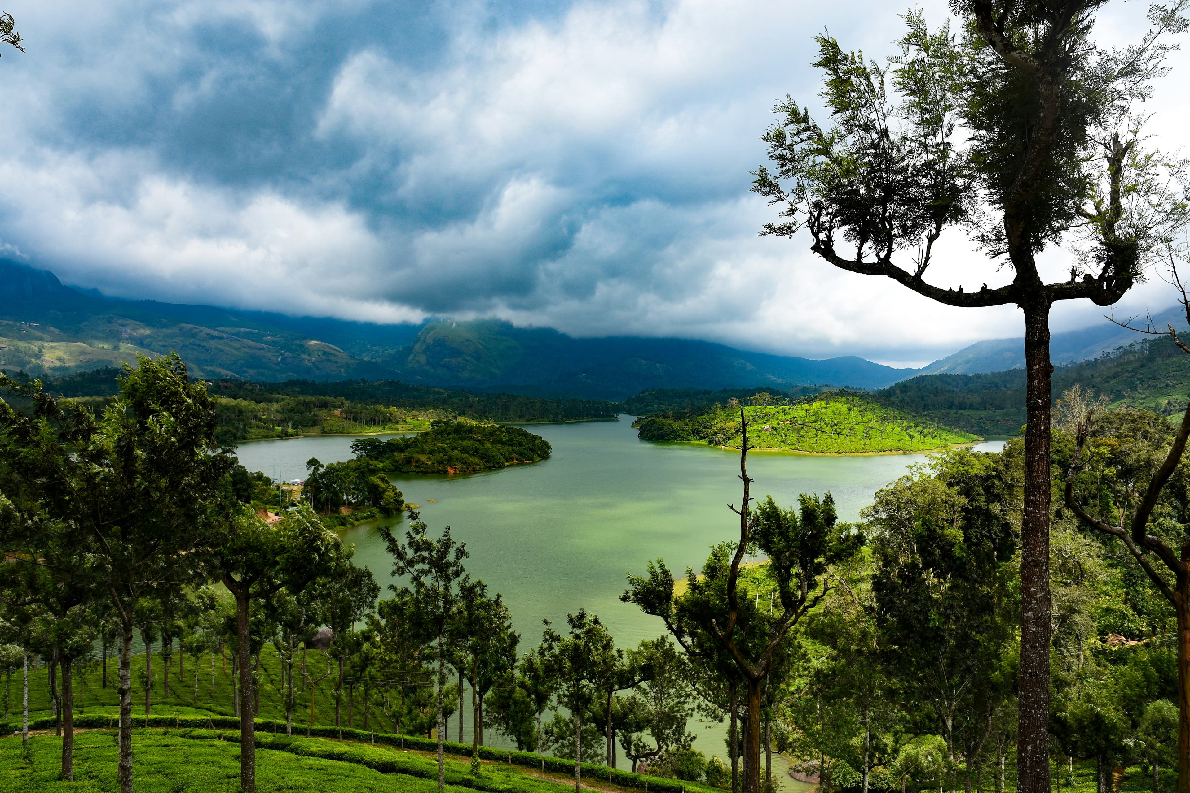 Forested lake under monsoon clouds