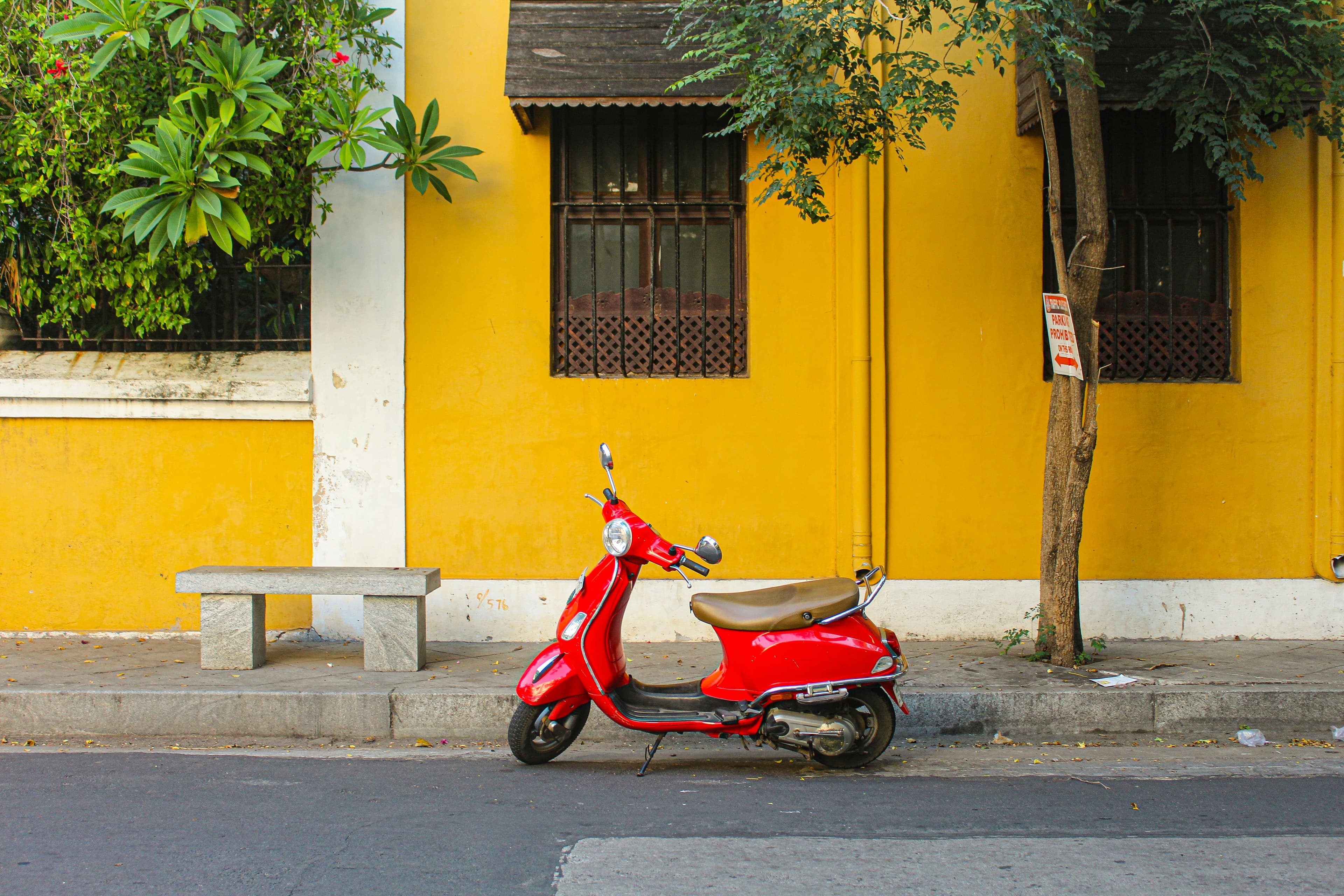 Red scooter outside a yellow colonial house, Pondicherry