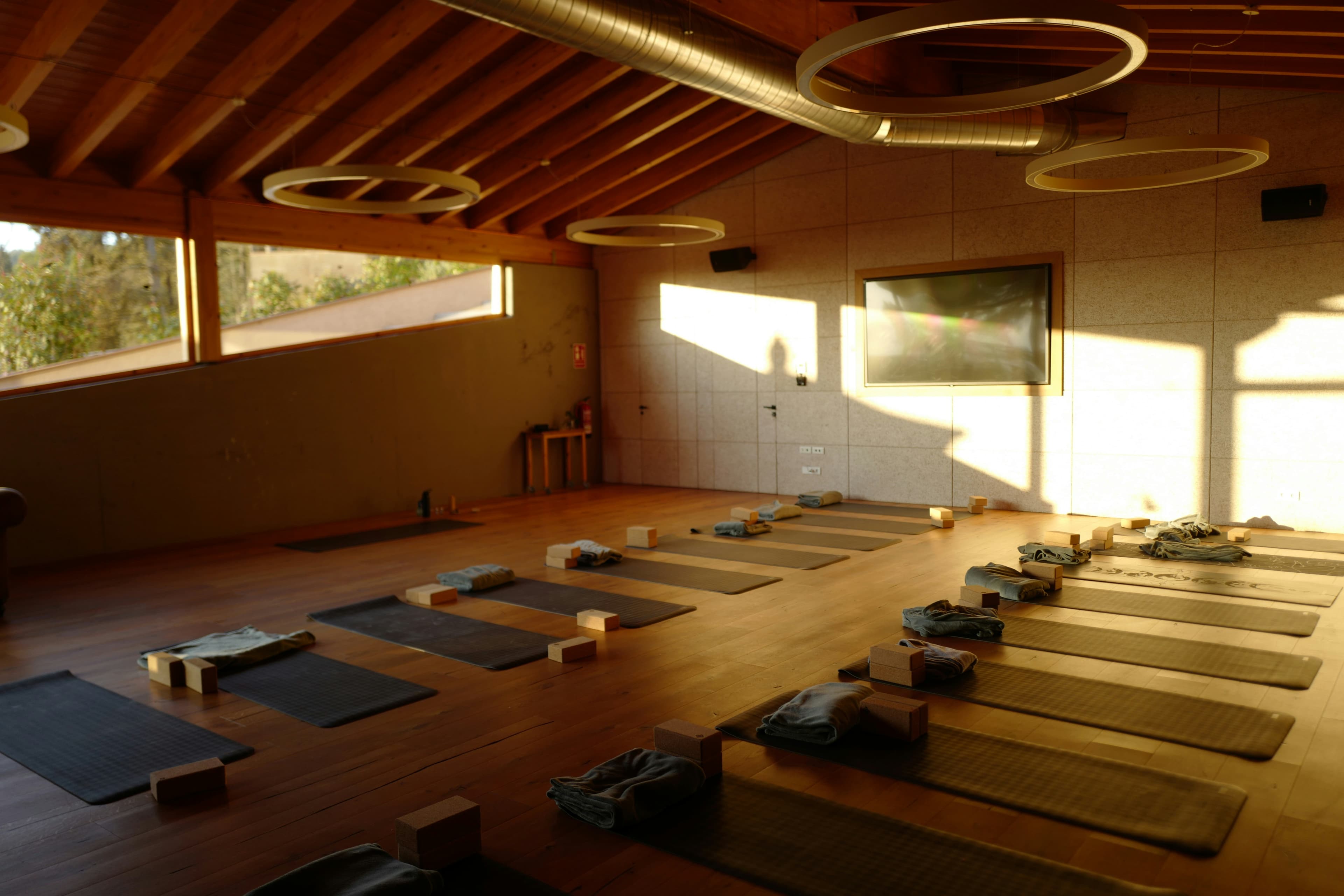 Wooden yoga shala laid out with mats