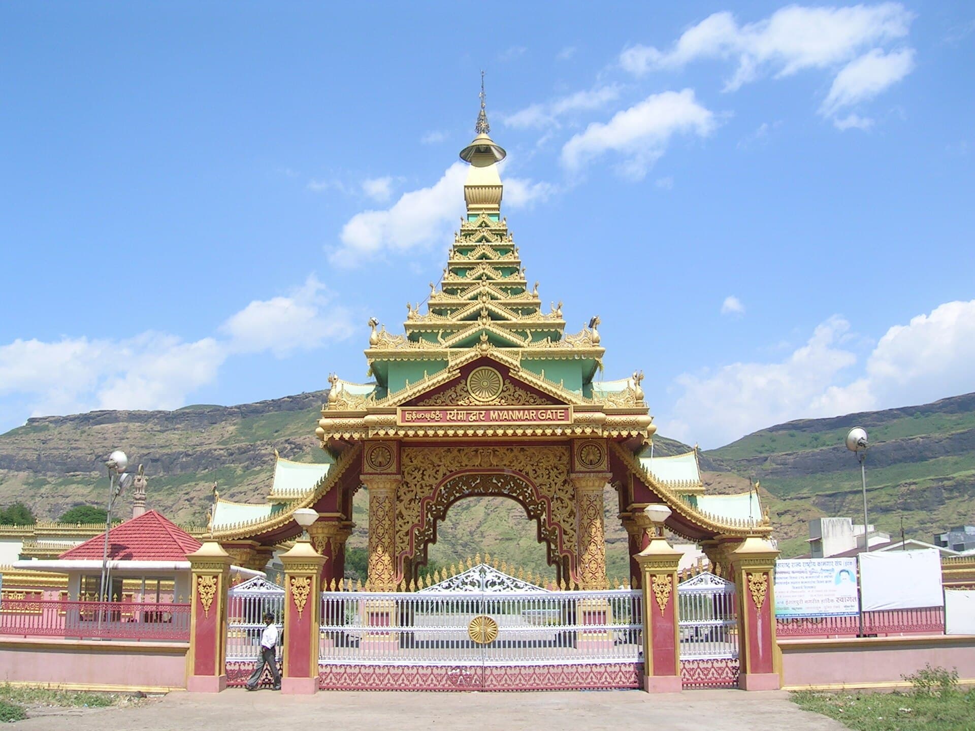 Myanmar-style gateway at Dhamma Giri against the Sahyadri hills